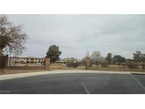 Gated community entrance with brick pillars, black iron fence, and landscaped common areas, providing security and curb appeal at 217 Via Luna Rosa Ct, Henderson, NV 89011