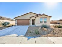 Single-story house with brown garage door and desert landscaping at 3811 E Chaffe Ave, Pahrump, NV 89061