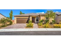 One-story home with brown garage door and landscaped front yard at 4390 E Cactus Canyon Dr, Pahrump, NV 89061