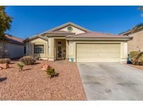 One-story house with a two-car garage and desert landscaping at 4826 Polar Lights Ct, Las Vegas, NV 89130