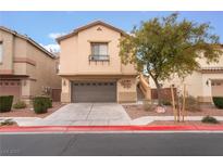 Two-story house with attached garage and landscaped front yard at 5916 Magic Oak St, North Las Vegas, NV 89031