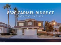 Two-story house with a three-car garage and landscaping at 8320 Carmel Ridge Ct, Las Vegas, NV 89113