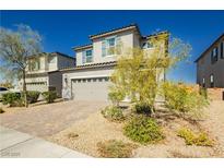 Charming two-story home with a brick driveway, desert landscaping, and a two-car garage at 1004 Huckburn Ave, Henderson, NV 89015