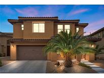 Charming two-story home with a desert landscape and an attached two-car garage at 1067 Via Saint Andrea Pl, Henderson, NV 89011