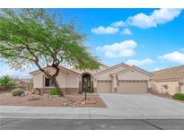 Charming single-story home boasts a well-manicured front yard, desert landscaping, and a spacious two-car garage at 2413 Cook Out Ct, Henderson, NV 89002