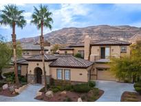 Two-story house with tile roof, stucco siding, and a three-car garage at 2475 Grassy Spring Pl, Las Vegas, NV 89135