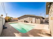 A backyard pool offers a refreshing escape with a concrete patio, perfect for relaxation and outdoor enjoyment at 2540 Eagle St, Las Vegas, NV 89142