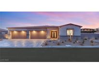 Stunning modern home with three-car garage and landscaped front yard at 2669 Pioneer Estates Ct, Las Vegas, NV 89117