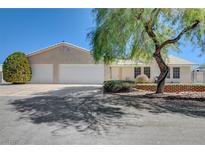 Single-story house with a three-car garage and mature landscaping at 303 Glasgow St, Henderson, NV 89015