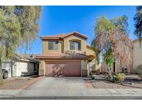 Two-story house with brown garage door and landscaped yard at 422 Waterbrook Dr, Henderson, NV 89015