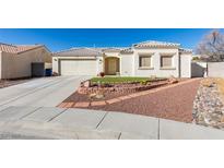 One-story house with attached garage, landscaped front yard, and a brick garden at 5417 Lemhi Ct, North Las Vegas, NV 89031