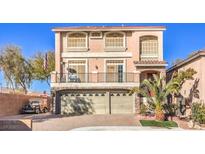 Charming two-story home features a balcony, three-car garage, and lush landscaping at 5490 Tulip Hill Ave, Las Vegas, NV 89141