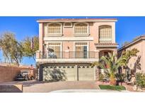 Two-story house with a two car garage and palm trees at 5490 Tulip Hill Ave, Las Vegas, NV 89141