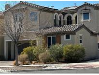 Two-story house with desert landscaping and a three-car garage at 7561 Tamany St, Las Vegas, NV 89143