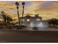 Two-story house with a three-car garage and mature landscaping at 908 Primrose Ln, Henderson, NV 89011