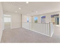 Spacious loft area with high ceilings and neutral carpeting at 1112 Via San Pietro, Henderson, NV 89011