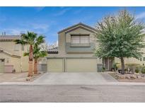 Two-story house with a three-car garage and landscaped front yard at 1125 Neva Ranch Ave, North Las Vegas, NV 89081