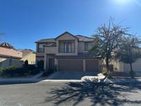 Two-story house with three-car garage and mature trees at 2273 Moresca Ave, Henderson, NV 89052