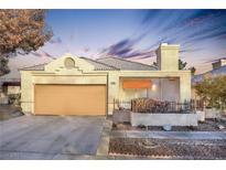 Single-story house with attached garage, landscaping, and a neutral color palette at 348 Wild Plum Ln, Las Vegas, NV 89107