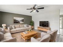 Bright living room featuring comfortable seating and a large TV at 3701 Guinevere Ave, Las Vegas, NV 89110