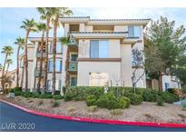 Exterior view of a modern condo building with palm trees and landscaping at 7167 S Durango Dr # 203, Las Vegas, NV 89113