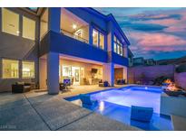 Stunning backyard featuring a pool, lounge area, and outdoor dining space, perfect for entertaining at 8 Hilltop Crest St, Henderson, NV 89011