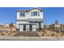 Two-story home with gray siding, stone accents, and landscaping at 8406 Sycamore Creek St, Las Vegas, NV 89113