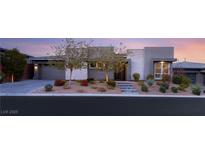 Modern home with stone accents and landscaped front yard at 10004 Terrastone Dr, Las Vegas, NV 89148