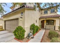 Inviting two-story home with a landscaped front yard and two-car garage at 2671 Colina Bella Ct, Las Vegas, NV 89142