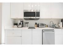 Modern white kitchen featuring stainless steel appliances and ample counter space at 29 Montelago Blvd # 337, Henderson, NV 89011