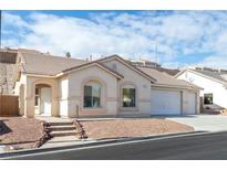 Single-story house with a two-car garage and landscaped yard at 2915 Rippling Springs St, Laughlin, NV 89029