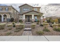 Two-story house with stone accents and landscaping at 3177 Bivona Walk, Henderson, NV 89044