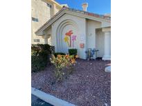 Property entrance with colorful palm tree decorations and manicured landscaping at 3550 Bay Sands Dr # 3081, Laughlin, NV 89029
