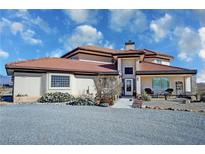 Single-story home with red tile roof, large windows, and landscaped yard at 3821 S Tumbleweed Ave, Pahrump, NV 89048