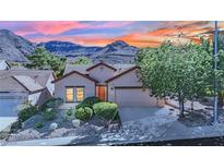 Charming single-story home featuring desert landscaping, attached garage, and stunning mountain views at 725 Pacific Cascades Dr, Henderson, NV 89012