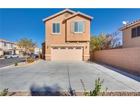 Inviting two-story home featuring a spacious driveway and attached two-car garage at 8736 Summoners Ct, Las Vegas, NV 89139