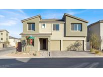 Two-story house with three-car garage, neutral color scheme, and landscaping at 10116 Rebel Coast St, Las Vegas, NV 89141