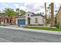 Single-story house with blue garage door and landscaped yard at 1045 Via Camelia St, Henderson, NV 89011