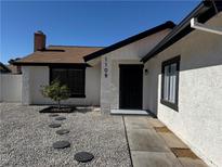 Inviting home exterior with desert landscaping, charming stone walkway and neutral color scheme at 1108 Smith St, Las Vegas, NV 89108