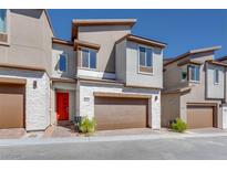 Modern two-story home with attached garage and red front door at 11904 Vector Ray Ave, Las Vegas, NV 89138