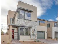 Modern two-story home with stone accents and two-car garage at 1225 Crimson Sunbird St, North Las Vegas, NV 89084