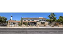 Two-story home features a low brick fence and desert landscaping in a classic suburban neighborhood at 1420 S 8Th St, Las Vegas, NV 89104