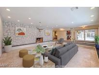 Spacious living room featuring a stone accent wall, fireplace and neutral decor, great for entertaining at 1420 S 8Th St, Las Vegas, NV 89104