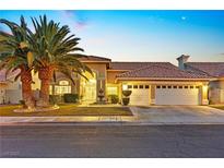 Stunning desert home with palm trees and a three-car garage at 1504 Castle Crest Dr, Las Vegas, NV 89117