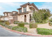 Two-story townhome with Mediterranean styling, landscaped grounds, and attached garage at 19 Via Visione # 204, Henderson, NV 89011