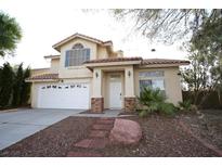 Two-story house with a brick facade, attached garage, and landscaped yard at 3390 Syvella Ct, Las Vegas, NV 89117