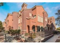 Spanish-style townhome with a two-story elevation, featuring a modern color scheme and landscaping at 3975 N Hualapai Way # 266, Las Vegas, NV 89129