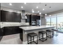 Modern kitchen with stainless steel appliances and an island at 4269 Solace St # 0, Las Vegas, NV 89135