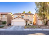 Two-story house with attached garage and landscaped front yard at 5031 Naff Ridge Dr, Las Vegas, NV 89131