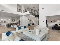 Open floor plan boasts high ceilings, modern fireplace, and ample natural light at 5219 Iron River Ct, Las Vegas, NV 89135